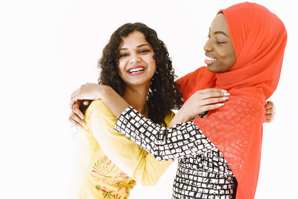 African and Asian women together on white background